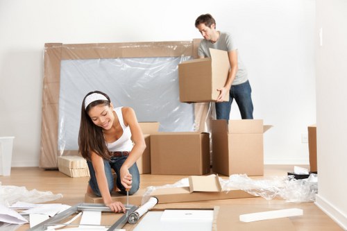 Removal company worker loading boxes into a moving van