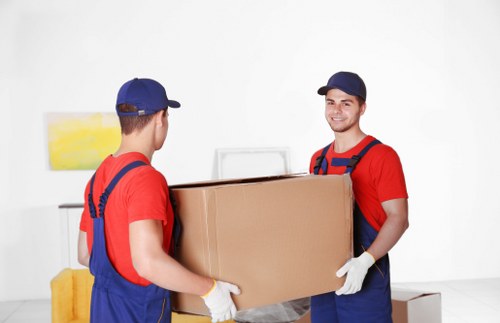 Removalists navigating stairs in a West Hampstead flat