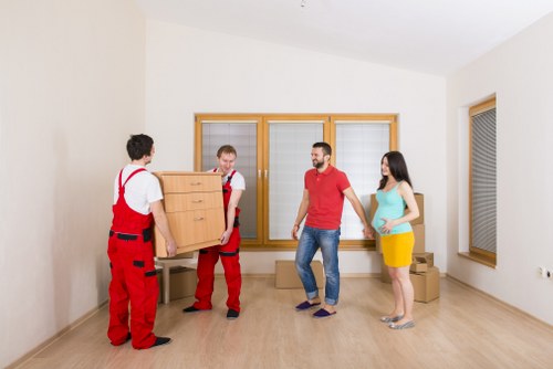 Professional movers handling furniture and boxes in a West Hampstead property