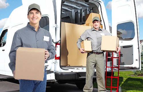 Professional removals team handling bulky furniture in West Hampstead