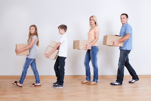 Packed boxes, desks, and workplace items ready for commercial transport